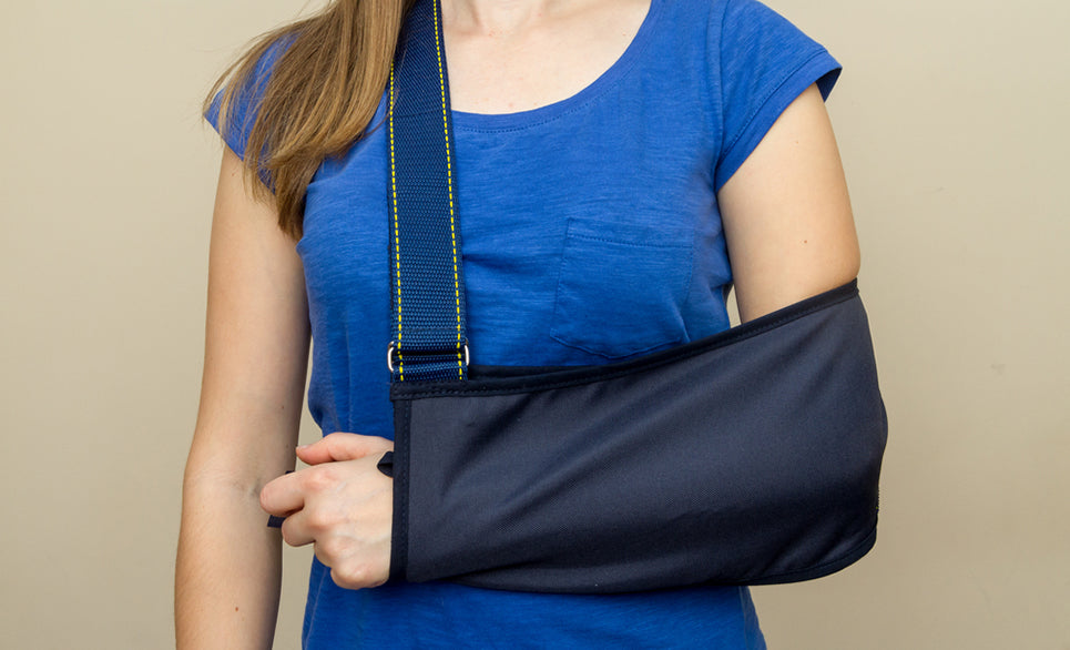 a woman with her arm in a sling