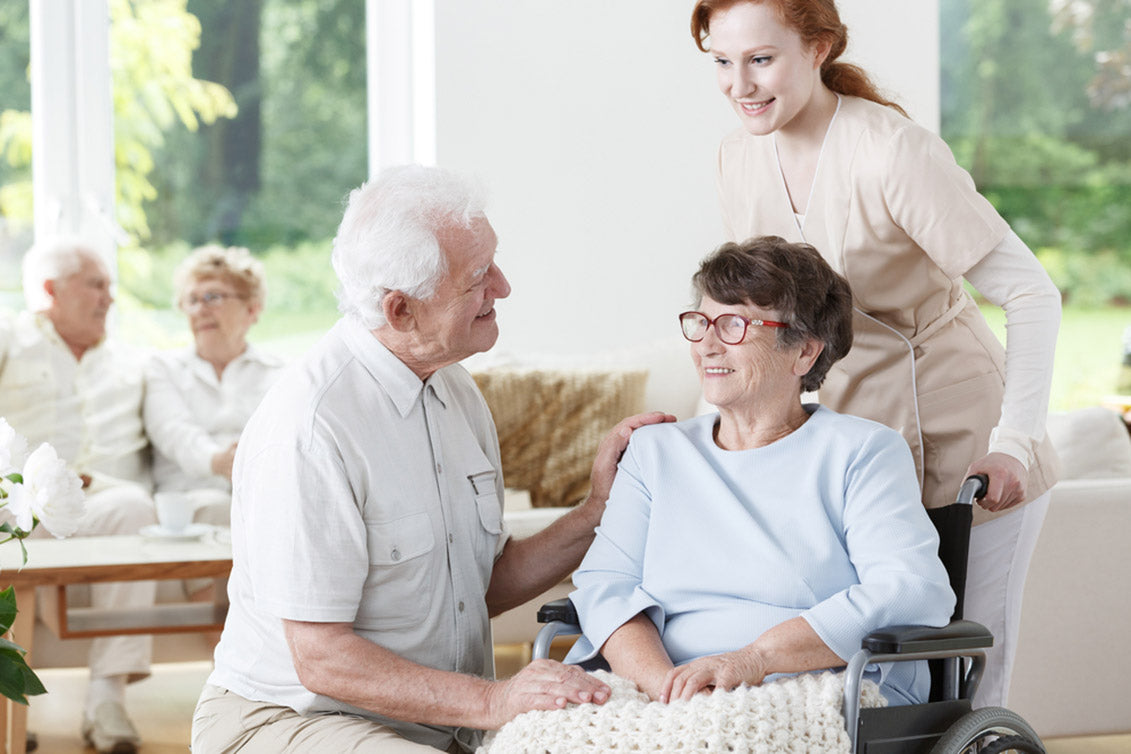 Elder man visiting his wife with Alzheimer's disease at the rest home