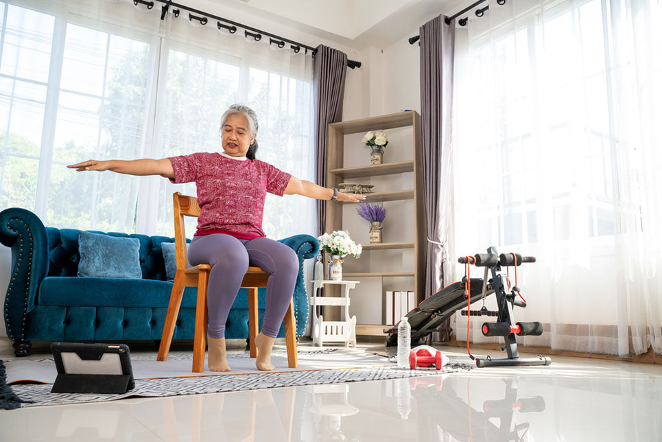 senior woman doing stretch sitting in chair