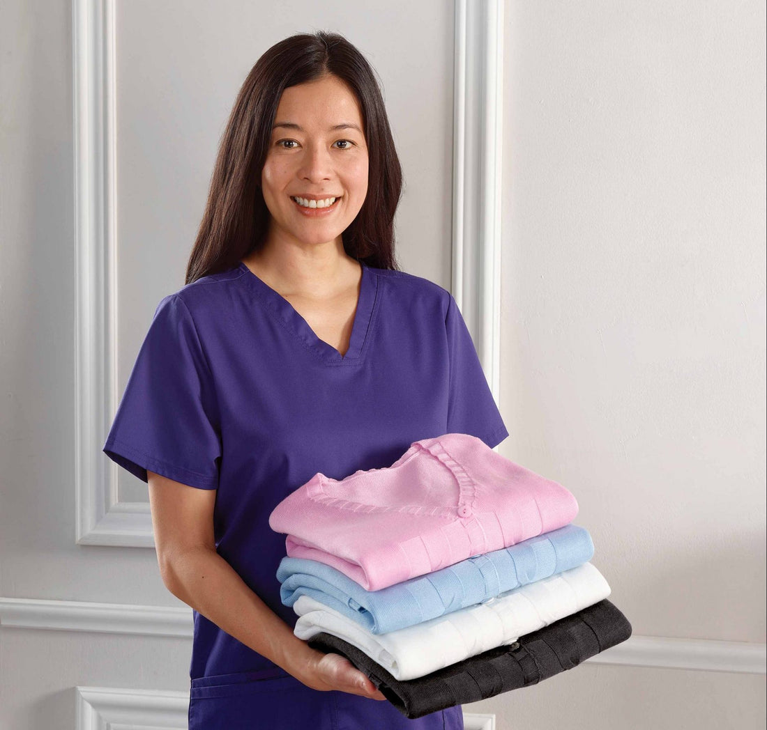 Care worker holding 4 folded cardigans
