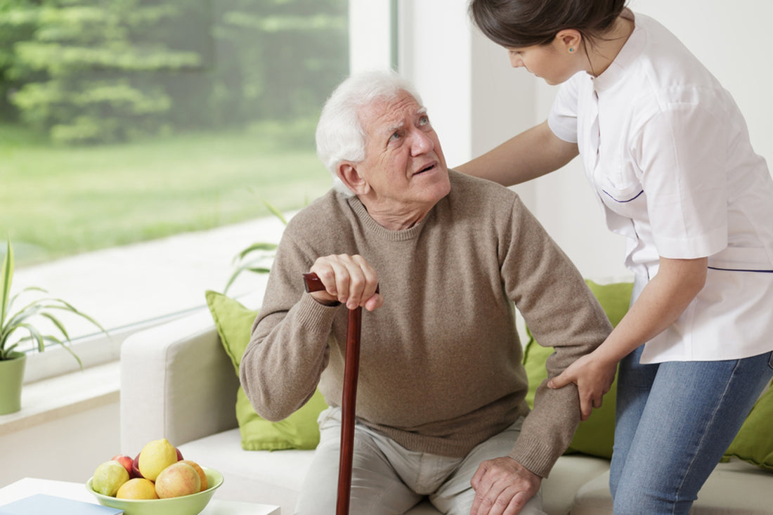 a Young woman helping an old man to stand up