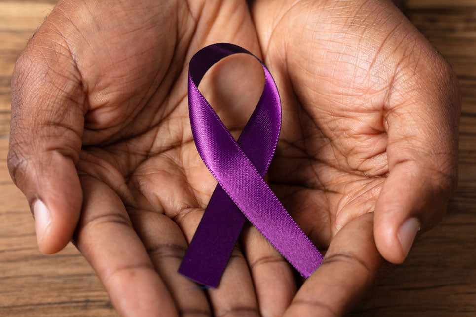 Close-up Of A Person's Hand Holding Ribbon To Support Alzheimer's Disease Awareness