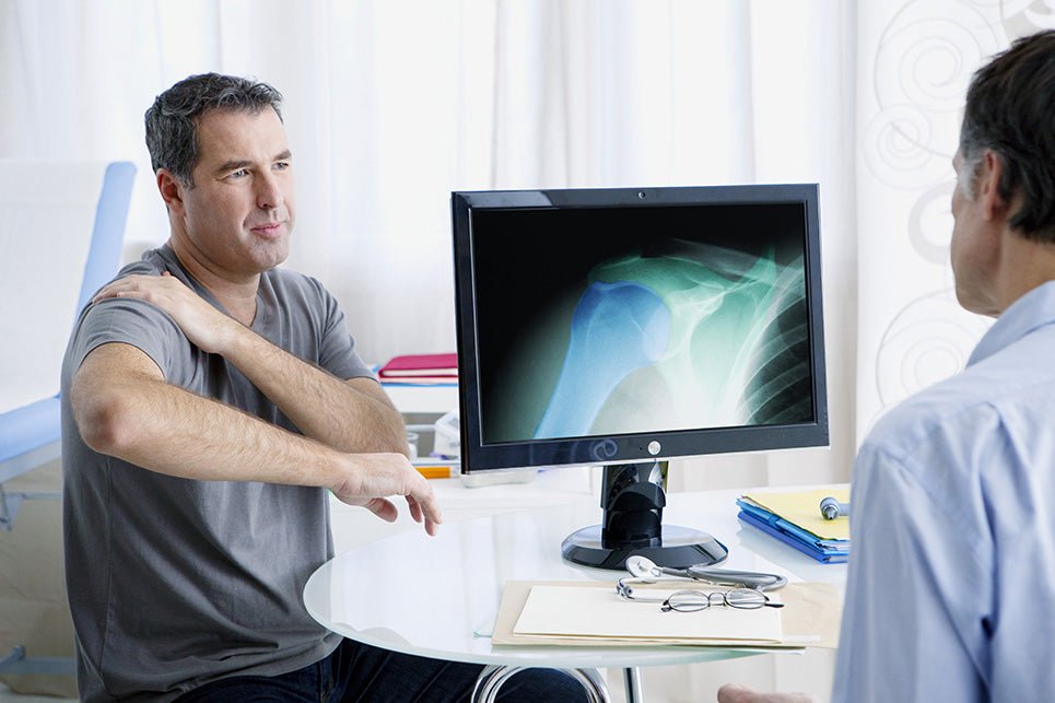 a man at a Rheumatology consultation with a doctor