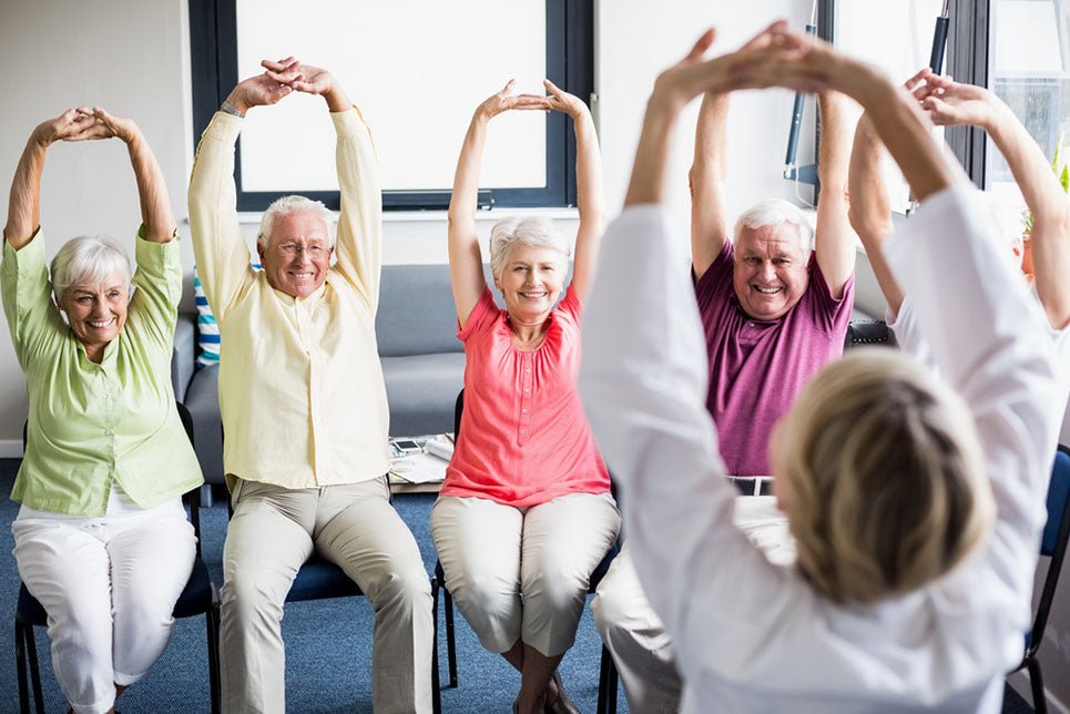 sitting seniors stretching arms upward